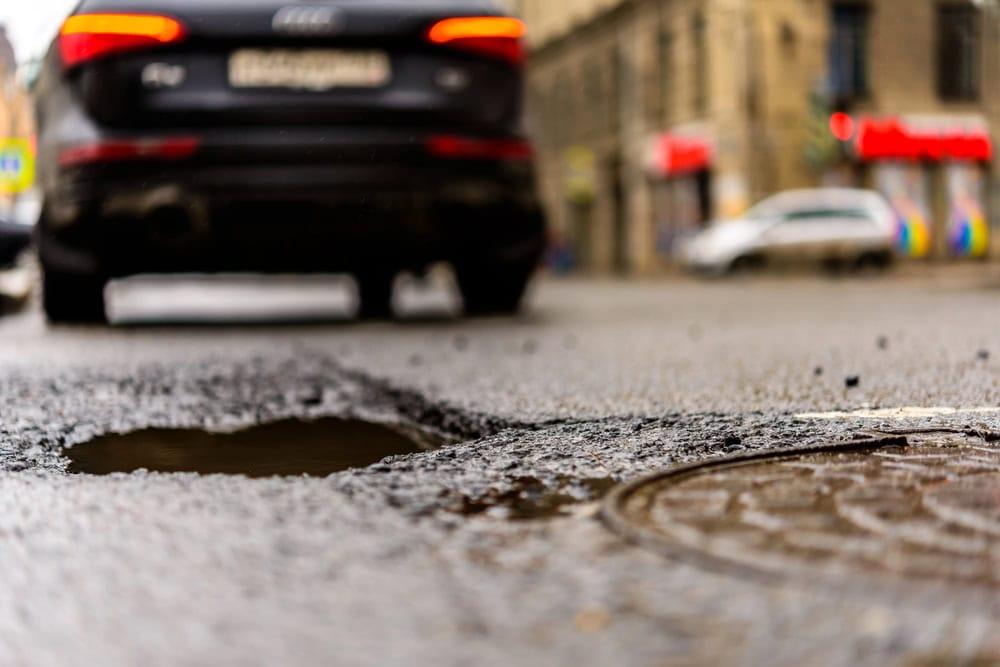 Personal injury attorney gathering witness statements after an accident caused by a pothole.
