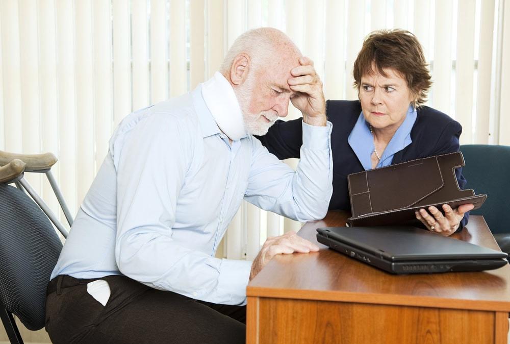 Chicago attorney meeting with a client to discuss a whiplash claim after a crash