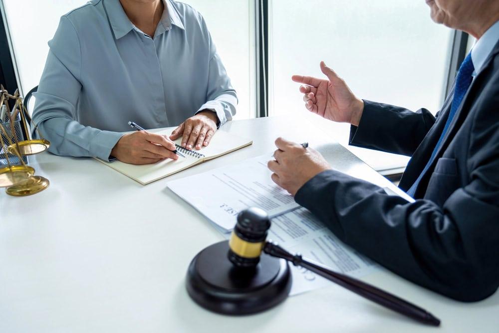 Attorney meeting with client to review liability after swerving to avoid a car accident