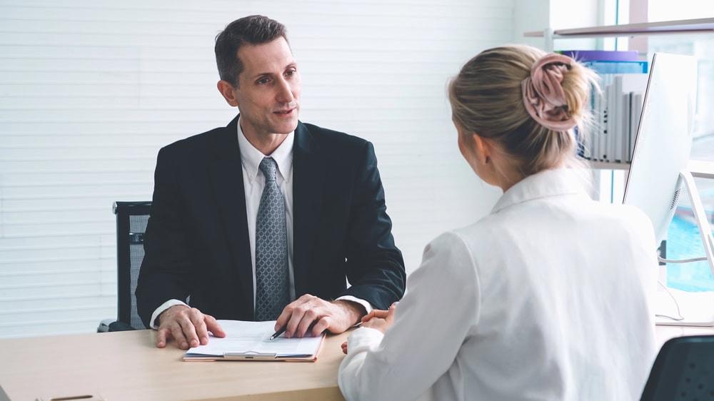 Attorney advising a car accident victim on dealing with insurance company delays