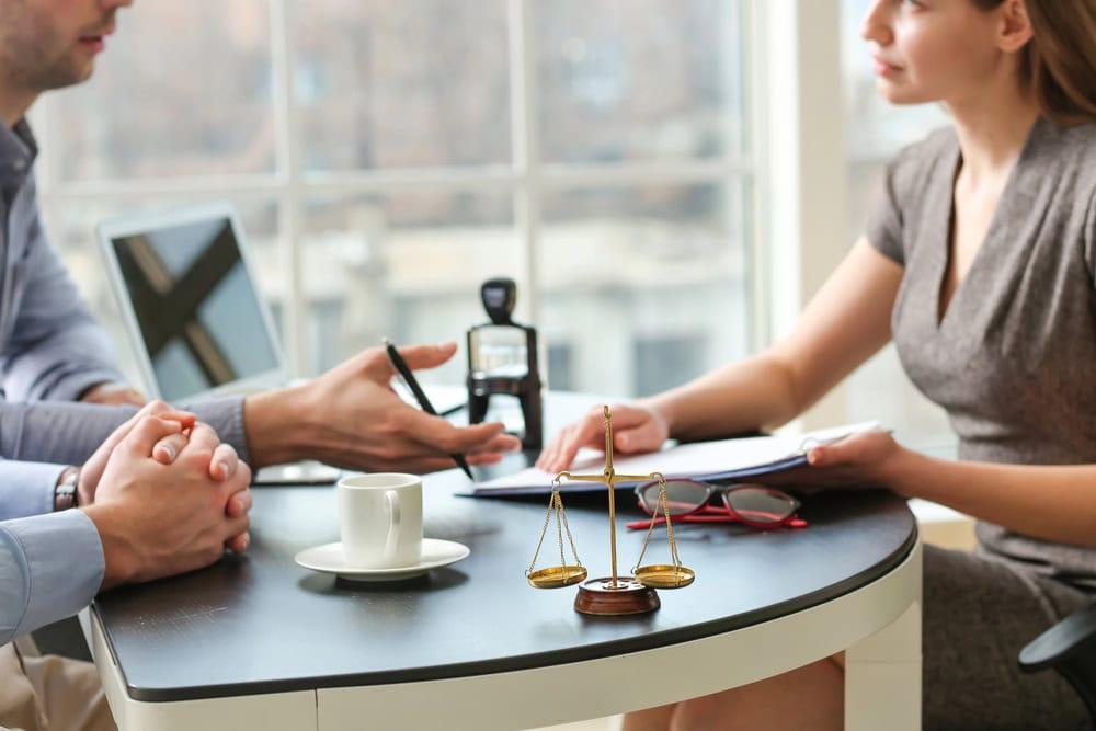 Aurora car accident lawyer meeting with a client to discuss a personal injury case.