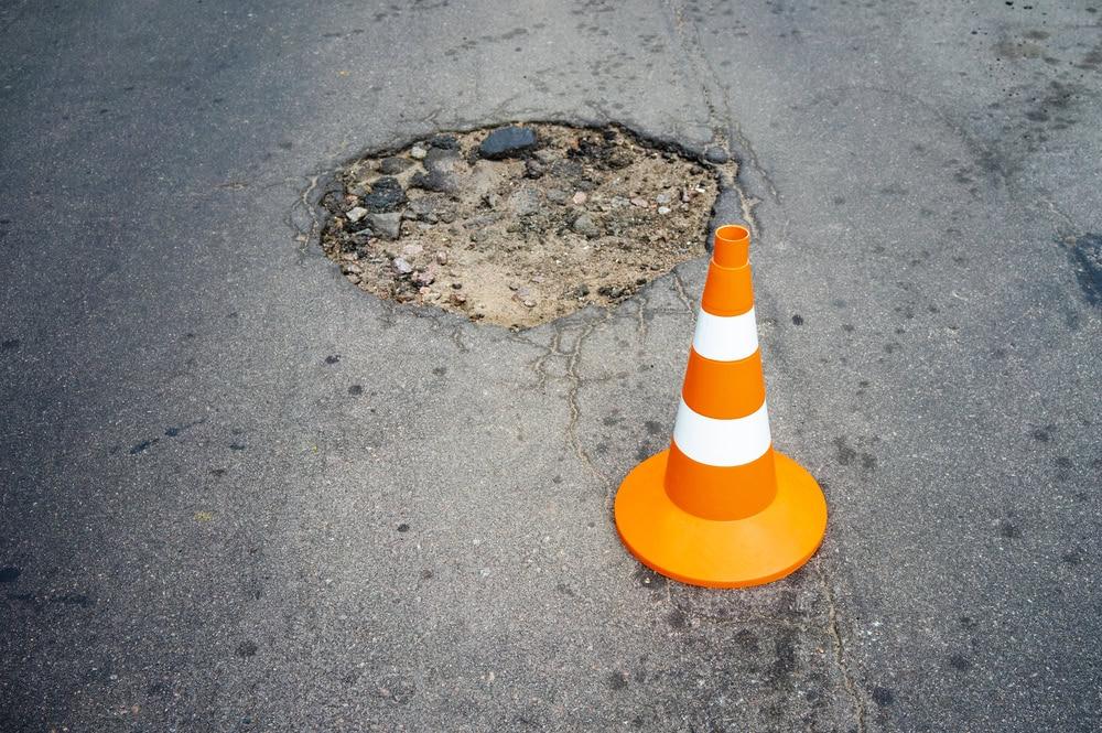A Chicago bicycle accident lawyer helping a cyclist injured after hitting a pothole.