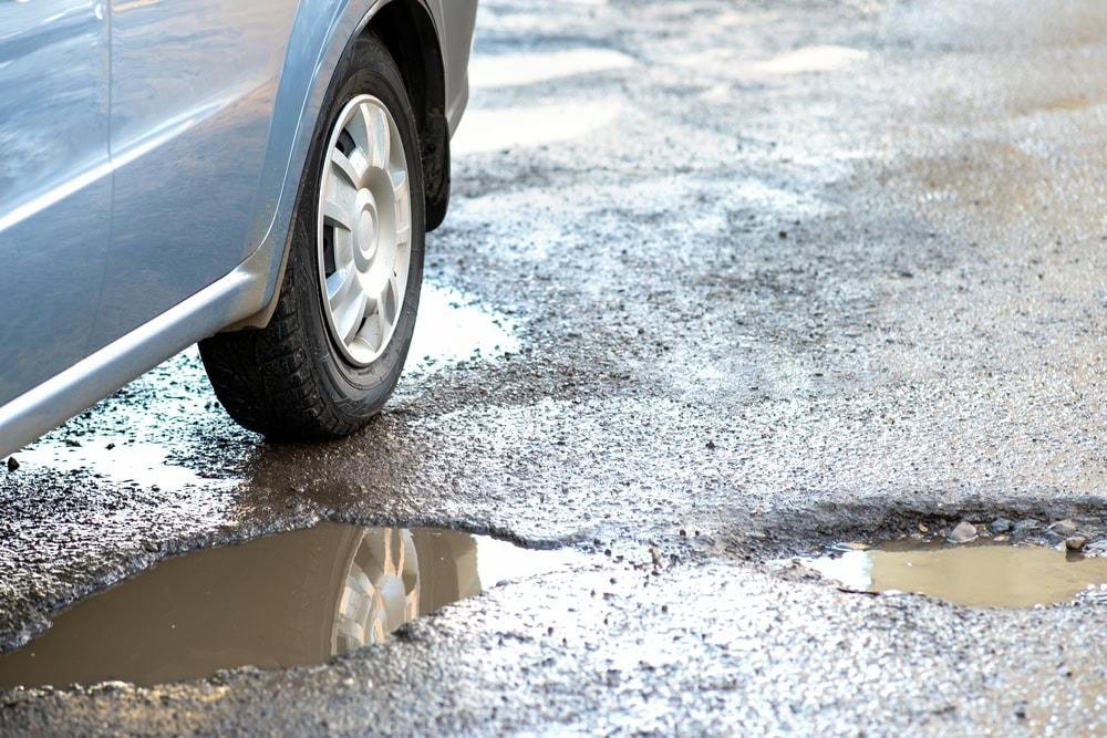 Large pothole on a Chicago street that caused a vehicle accident and injury.