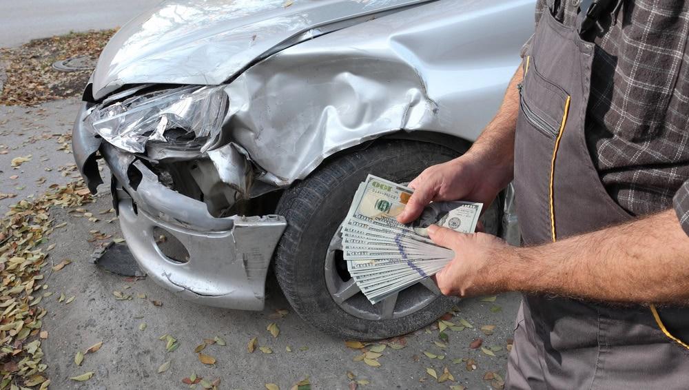 Law firm attorney explaining insurance company repair cost dispute after car accident.