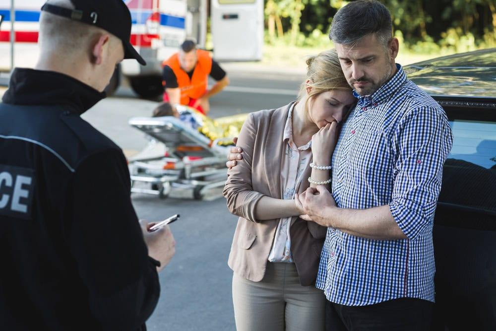 Police officer writing a police report at the scene of a car accident in Chicago.