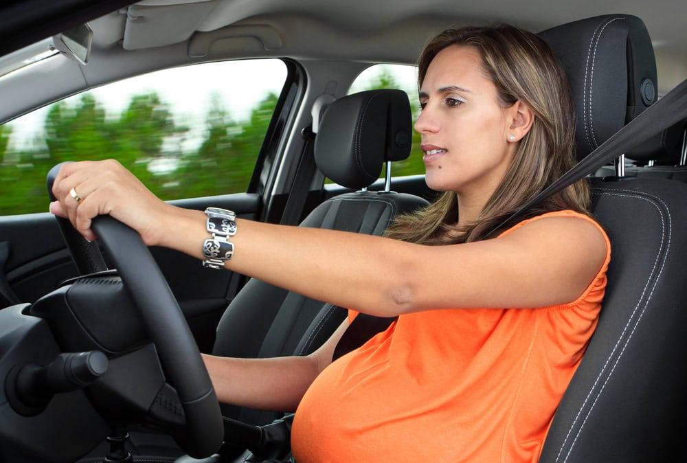Attorney meeting with pregnant woman to discuss injuries from a recent car accident